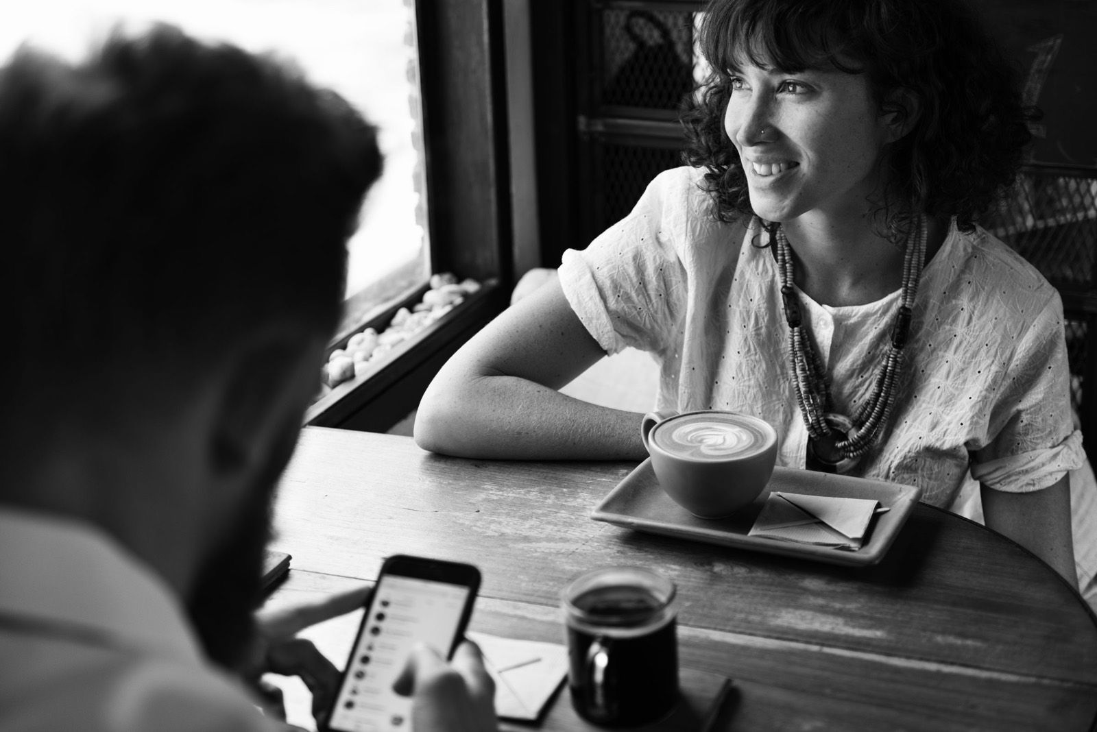 A couple talking over coffee at a café table